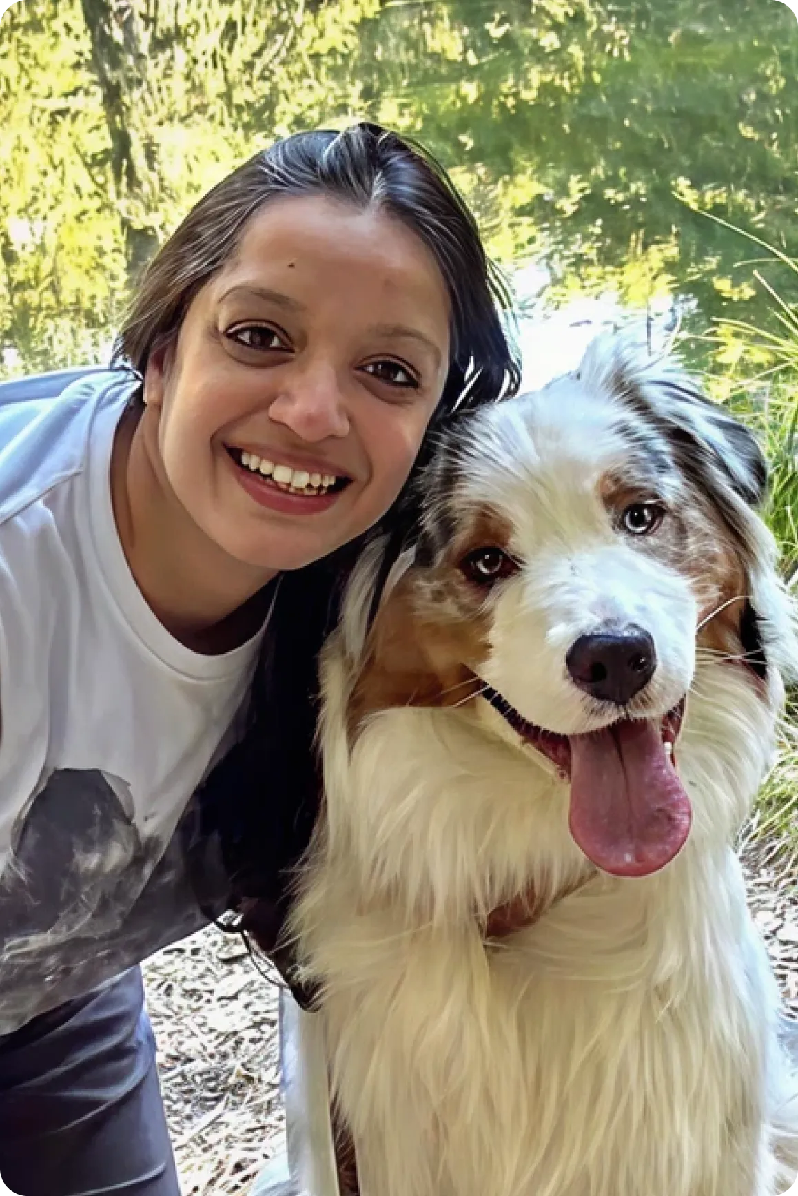Alisha hugging her Australian Shepherd